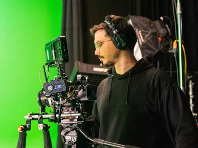 Ario operating camera on green screen stage