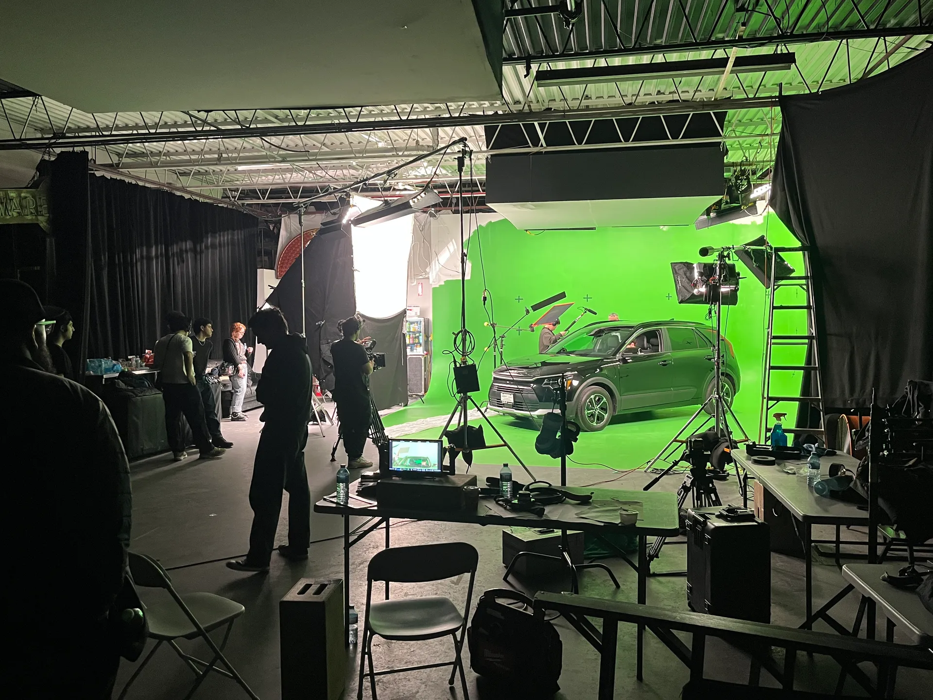 Crew operating camera on green screen stage